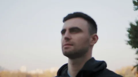 Man warms up before jogging in the background of the cityscape Stock Footage 122674080