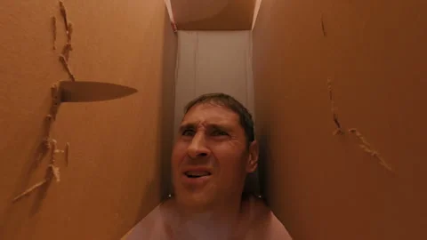 The man was placed with his head in a box and threatened with knives. Stock Footage 317177159