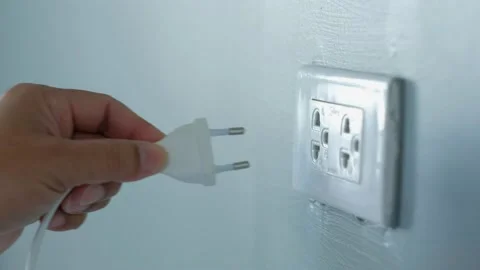 The man was plugging in an electric appliance in his house. Stock Footage 149052076