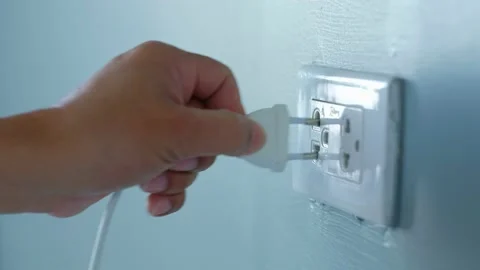 The man was plugging in an electric appliance in his house. Stock Footage 149667767
