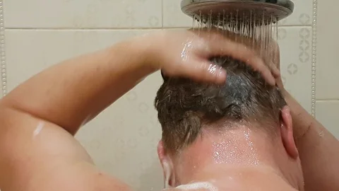 Man wash shower head Stock Footage 89231177