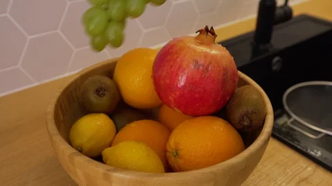 A man washed a bunch of grapes and put them on the fruit plate Stock Footage 129054483