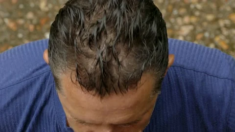 The man is washed by rainwater Video stock 86162370