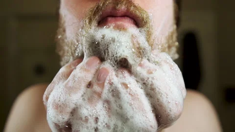 Man Washes Beard with Shampoo, Smiles at Camera Stock-Footage 139995626