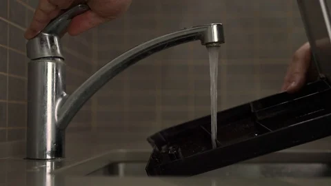 Man washes black plastic coffee machine removable drip tray Stock Footage 119158284