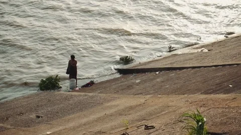 Man washes in Cambodia river Stock Footage 132078146