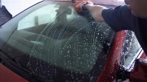 A man washes the car with foam on his own Video stock 160948020