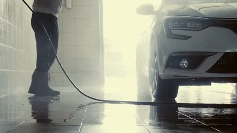 The man washes the car. He washes the foam off the car. Car wash. 4k Stock-Footage 89095122