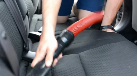 The man washes the car inside (interior) - vacuuming Stock Footage 38704290