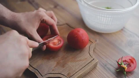 A man washes, cleans and cuts vegetables Stock Footage 131493184