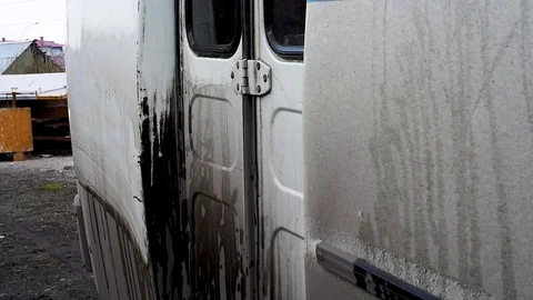 A man washes a dirty bus in the open air Stock Footage 108012337