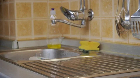 Man washes dirty dishes in kitchen Stock Footage 87304914