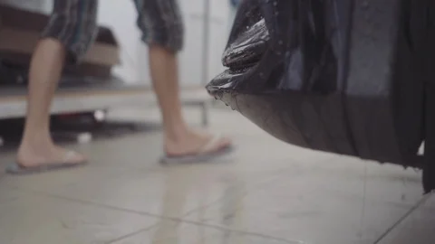 A man washes the front of the car before applying a protective layer on it Stock Footage 93603044