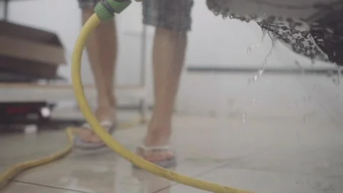 A man washes the front of the car before applying a protective layer on it Stock Footage 93603406