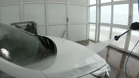 A man washes the front of the car Stock Footage 104281898