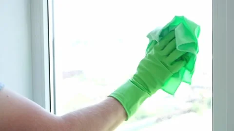 A man washes glass window and a plastic frame with a folk remedy with household Stock Footage 204159593
