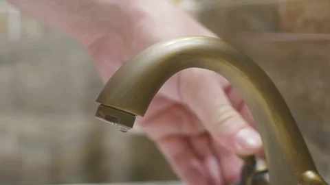 Man washes hands in kitchen sink. 4k. Stock Footage 79472912