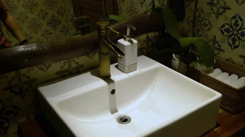 A man washes hands with soap in a sink Stock Footage 91452404