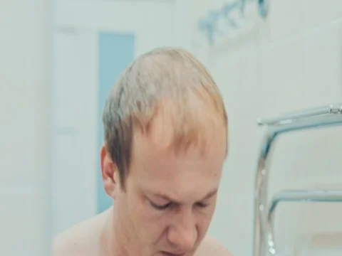 A man washes himself in the bathroom. Slow motion Stock Footage 74146009