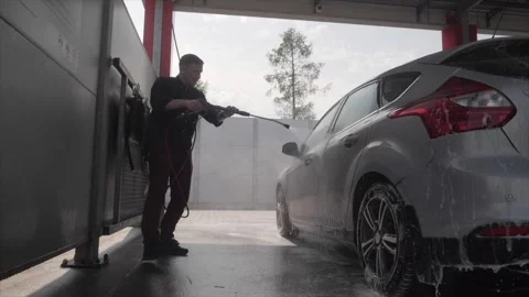 The man washes his car Vídeo Stock 248605539