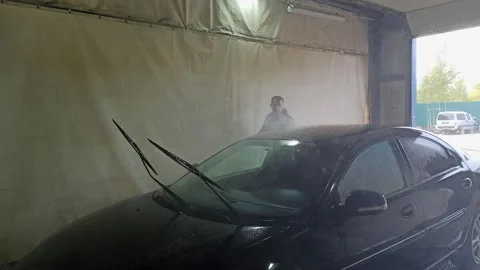 A man washes his car. A guy in a self-service service. Stock Footage 140046085