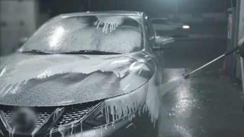 Man washes his car at self-service car wash, covers car with washing foam Stock Footage 140942830