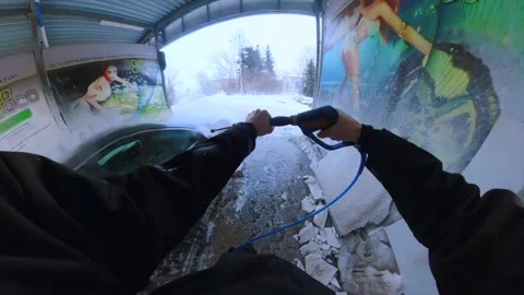 A man washes his car at a self-service car wash Stock Footage 234047676