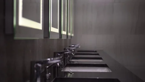 A man washes his face and hands in the bathroom. Cleaning Hands. Hygiene. Stock Footage 78302801