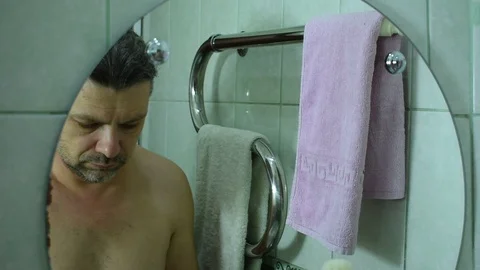 Man washes his face and wipes himself with a towel Stock Footage 122123968