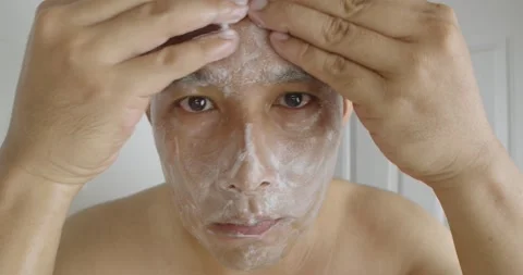 Man washes his face with soap to clean the skin and treat acne. Stock Footage 238738410