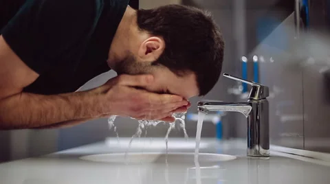 A man washes his hands and face. Slow motion Stock Footage 47897461