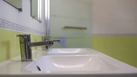 A man washes his hands and face in the morning. Stock Footage 72770326