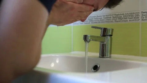 A man washes his hands and face in the morning. Stock Footage 72772144