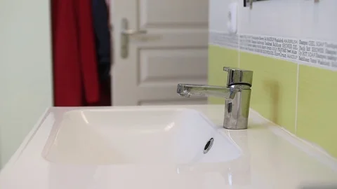 A man washes his hands and face in the morning. Stock Footage 72774577