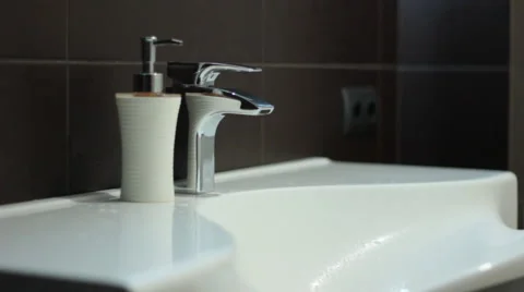 A man washes his hands in the bathroom  Stock Footage