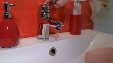 Man washes his hands in the bathroom Stock Footage 73234691