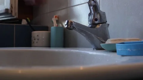 Man washes his hands in the bathroom Stock Footage 75061385