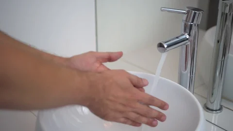 Man washes his hands, closeup view. Bathroom, white modern washbasin, chrome tap 스톡 동영상 121878406