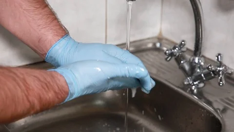 Man washes his hands with gloves Stock Footage 100349527