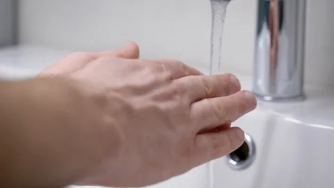 A man washes his hands in his bathroom. Men's hands in the frame, a modern house Stock Footage 128749558