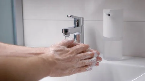 A man washes his hands in his bathroom. Men's hands in the frame, a modern house Stock Footage 129005294