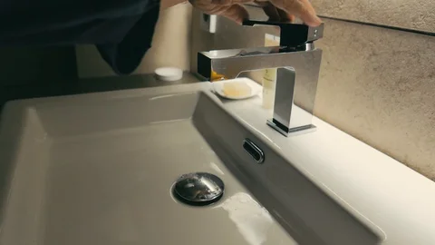 Man washes his hands in a modern sink Stock Footage 102694568