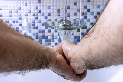 A man washes his hands Stock Photos