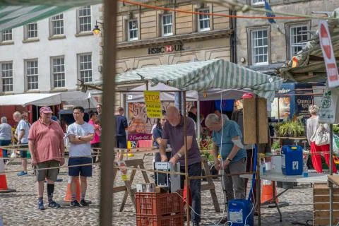 Man washes his hands as a precaution due to covid at an outdoor market Stock Photos