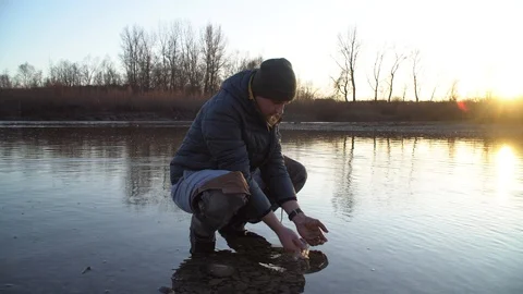 The man washes his hands in the river. Cold water Stock Footage 120698925