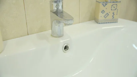 A man washes his hands in the sink Stock Footage 128542096