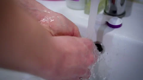 Man washes his hands in the sink. Hygiene and preventing germs from getting on Stock Footage 313981257