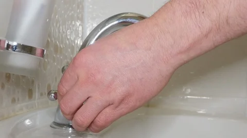 Man washes his hands with soap under the tap in the toilet 스톡 동영상 102806249