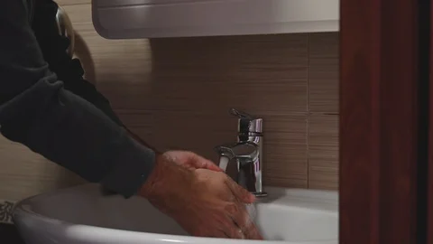 A man washes his hands with soap Stock Footage 127834680