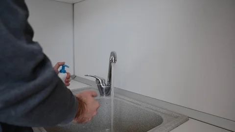 A man washes his hands with soap Stock Footage 127834800